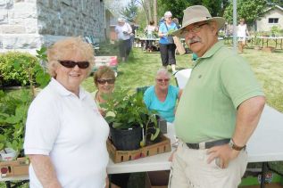 Members of the Grandmothers-by-the- Lake group, Adele Colby and Connie Taylor-Southall with newbie buyers Alison and John Turcotte at the groups annual plant & bake sale in Harrowsmith on May 31